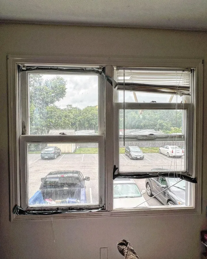 Replacement windows taped in place during installation
