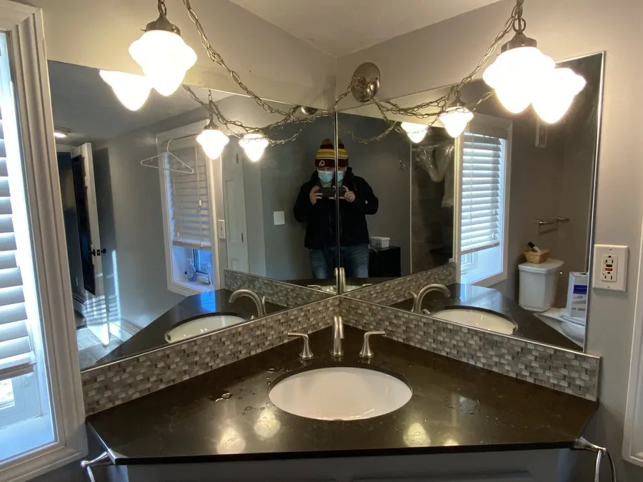 Custom corner vanity mirror above a double sink