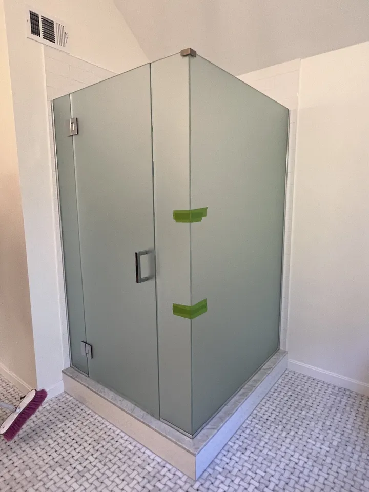 Frosted glass shower doors in a finished bathroom