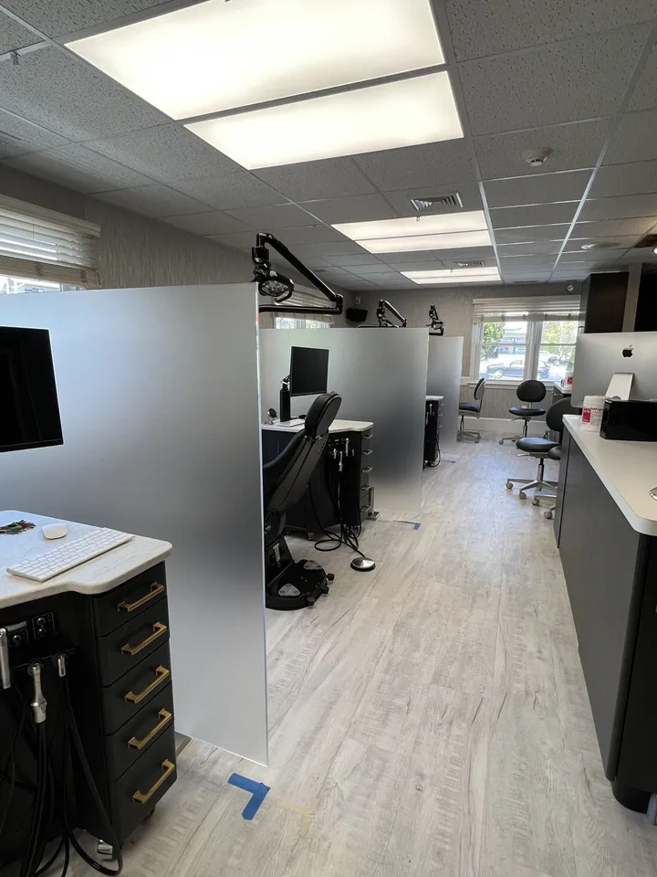 Frosted glass privacy partitions between dental office chairs