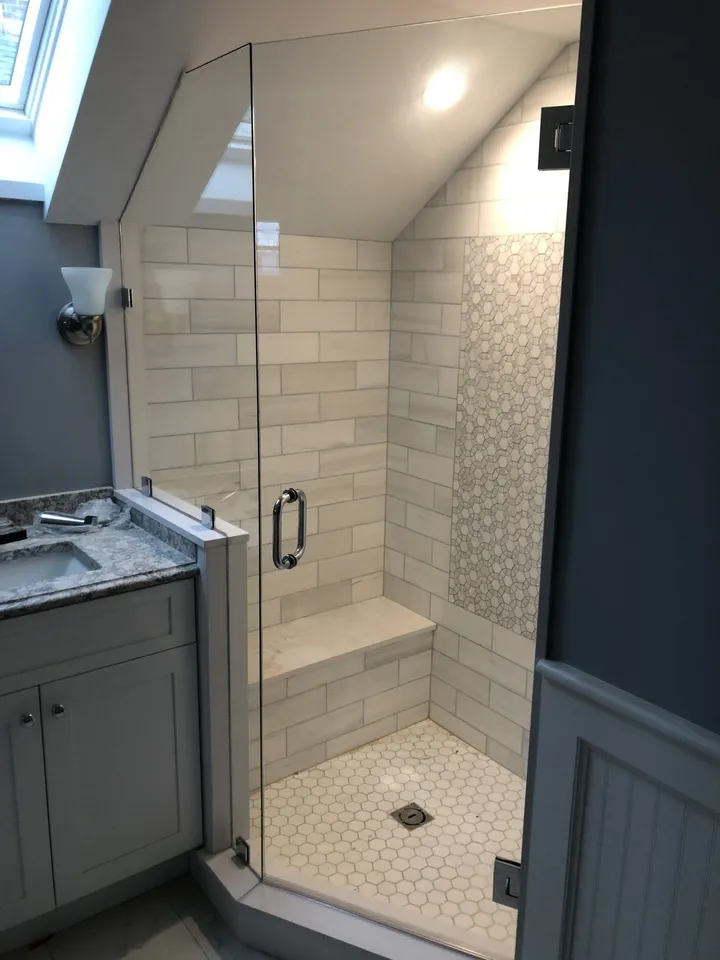 Glass shower enclosure beside a vanity