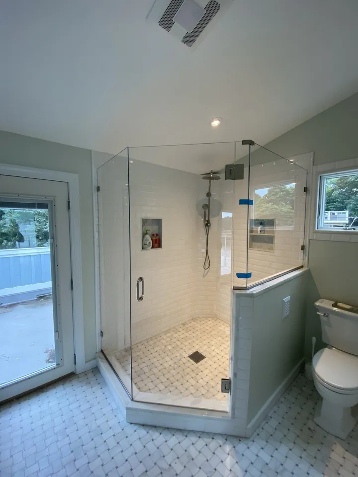Glass shower enclosure with a tiled niche