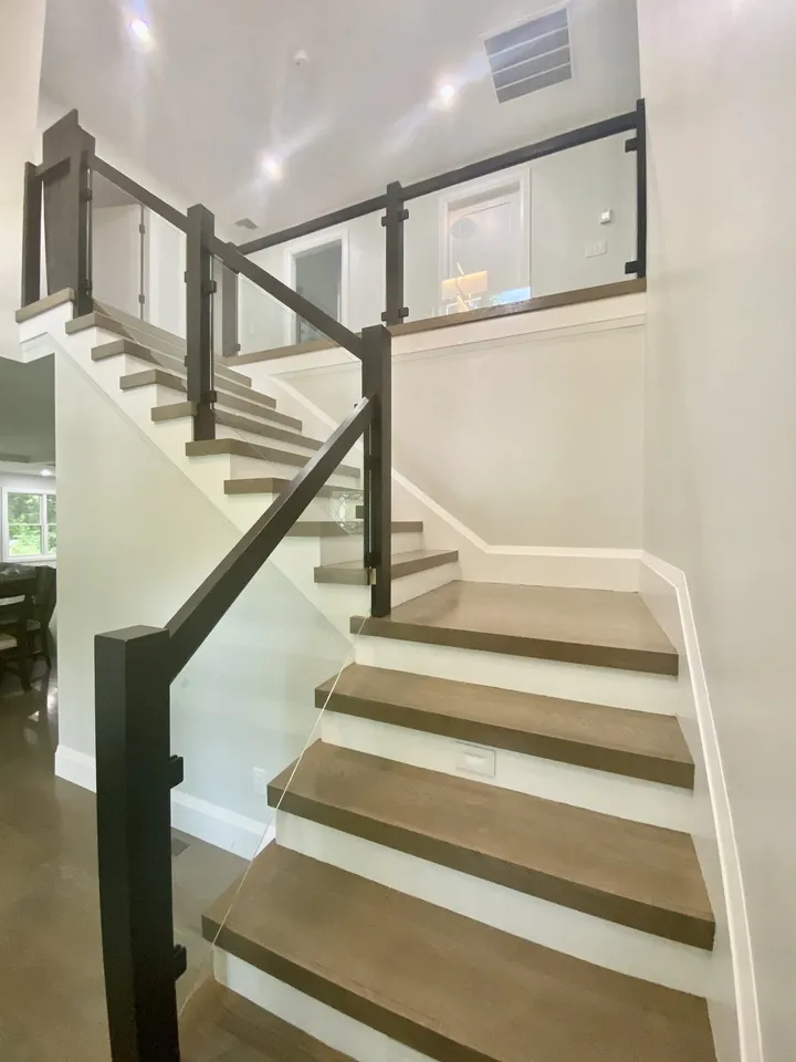 Glass stair railing with black posts