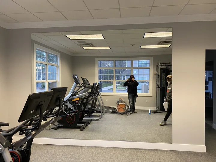 Mirrored wall in a gym at a pool house