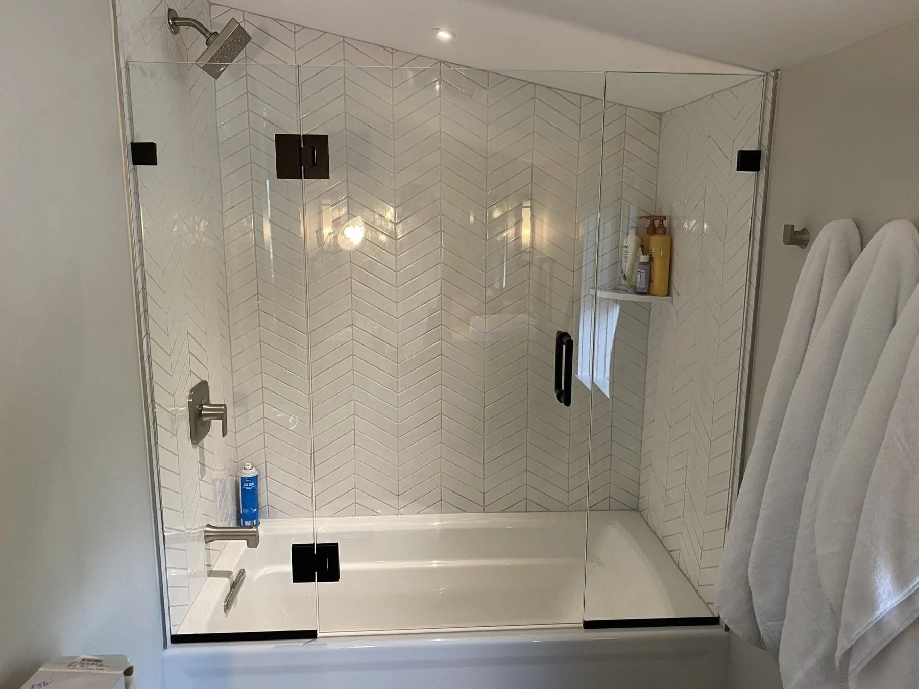Glass shower screen installed over a bathtub by J.S Glazing LLC