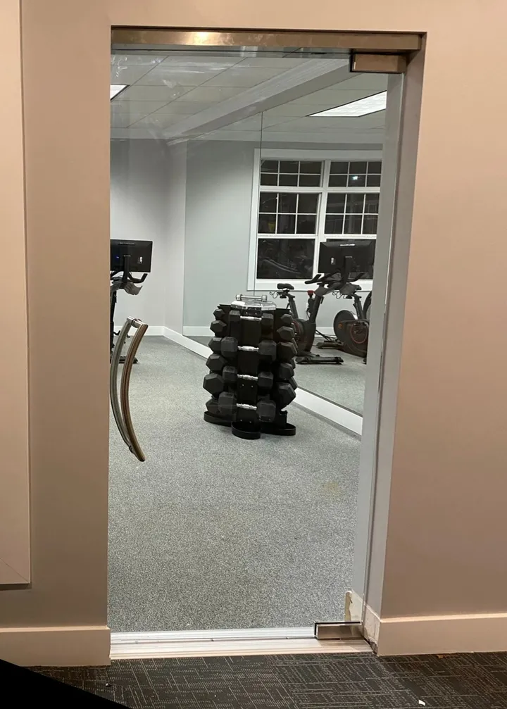 Glass entry into a gym at a pool house