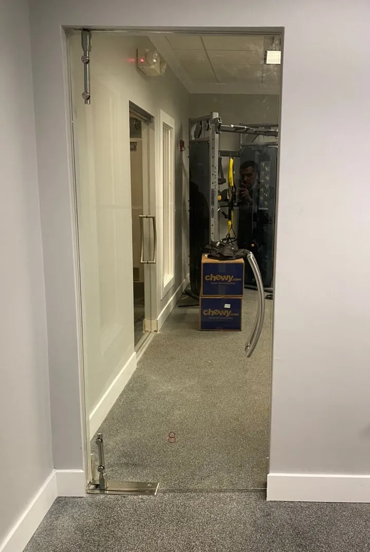 Glass doors along a walkthrough to a gym