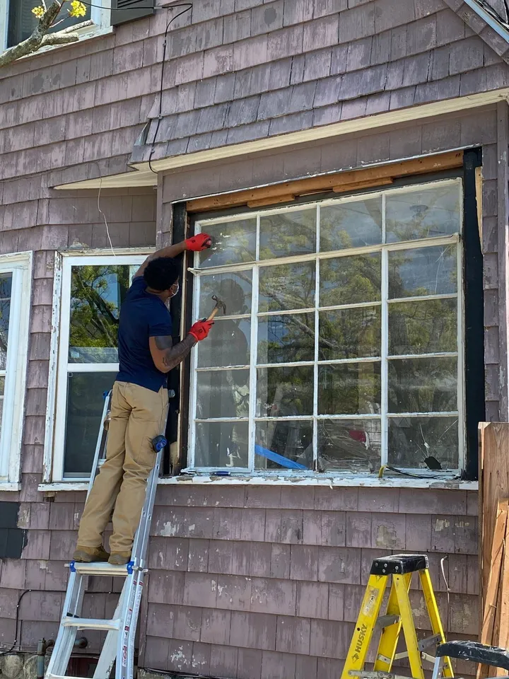 Technician installing a replacement window